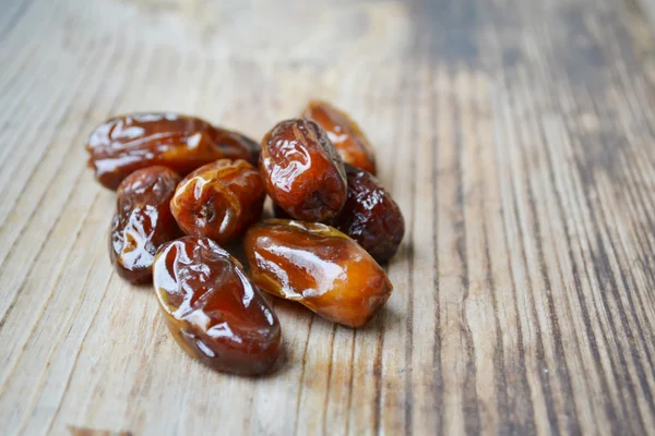 Brown dates fruit on wooden table — Stock Photo, Image