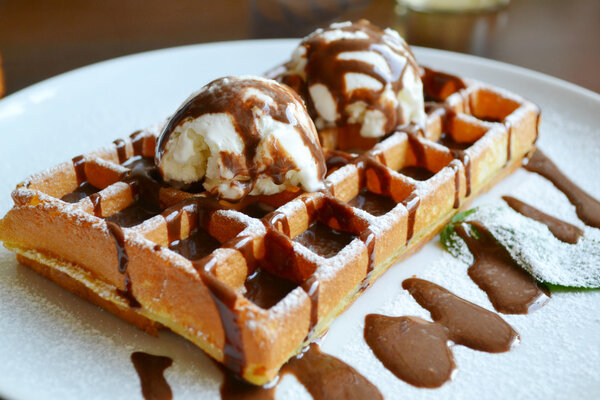 Belgian waffle with ice cream, chocolate and mint