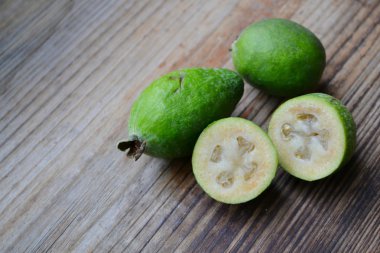 Ahşap masa üzerinde yeşil feijoa meyve