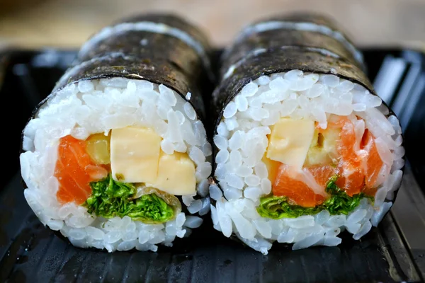 Delicious rolls and sushi with salad, salmon and philadelphia — Stock Photo, Image