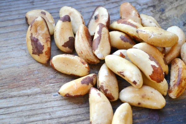 Bunch of Brazil nuts on wooden table — Stock Photo, Image