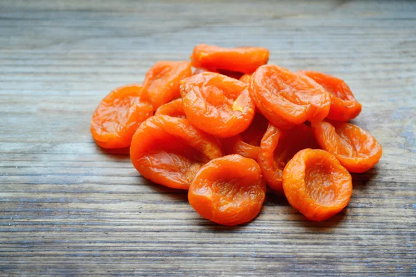 Dried apricots on wooden table