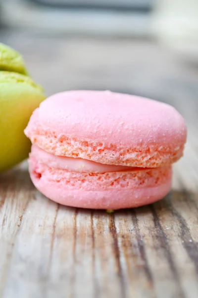 Macaron francês rosa em uma mesa de madeira — Fotografia de Stock