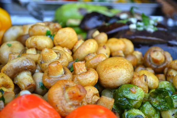 Roasted mushrooms champignons with tomatoes and Iceberg lettuce