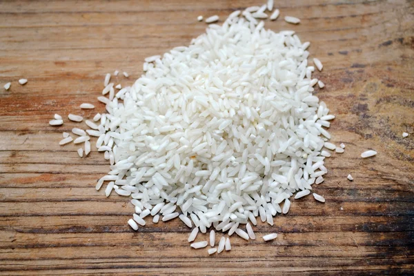 Arroz de grano largo sobre fondo madera — Foto de Stock