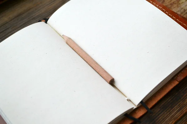 An empty retro notebook with old paper, little pencil and leather cover — Stock Photo, Image