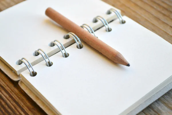 An empty retro notebook with old paper and little pencil — Stock Photo, Image