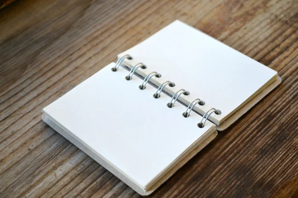 An empty retro notebook with old paper on wooden table — Stock Photo, Image