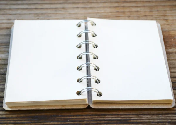 An empty retro notebook with old paper on wooden table — Stock Photo, Image