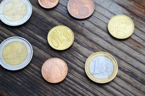 Euro coins on wooden table — Stock Photo, Image