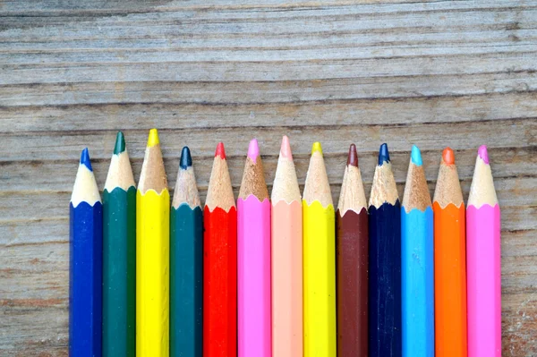 Set of colorful pencils on wooden table — Stock Photo, Image