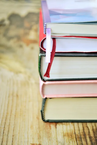 Pile of books on wooden desk — Stock Photo, Image