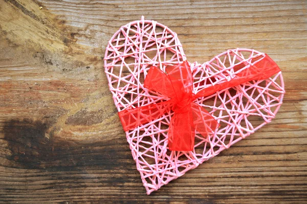 Pink handmade heart with red ribbon bow for St Valentine's Day — Stock Photo, Image