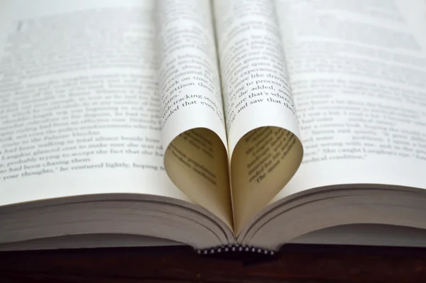 Book pages curved into a shape of heart — Stock Photo, Image