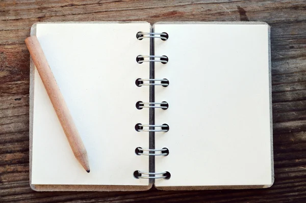 An empty retro notebook with old paper and little pencil — Stock Photo, Image