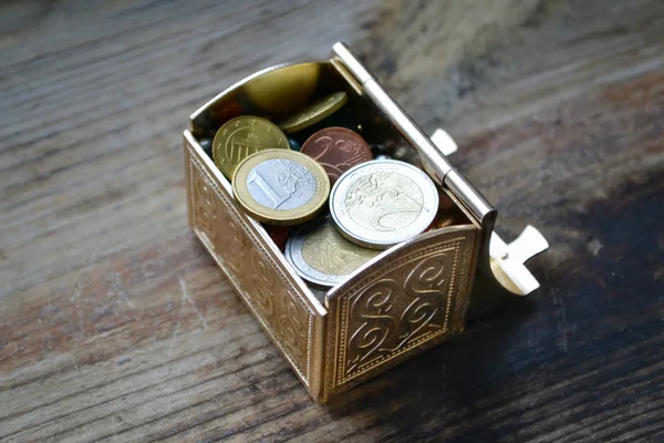 Little treasure chest with euro coins on wooden table — Stock Photo, Image