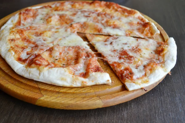 Whole pizza margherita on wooden plate — Stock Photo, Image