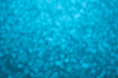 Parıldayan ile parlak ve soyut mavi arka plan bulanık glitter