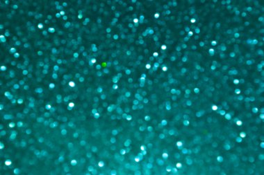 Parlak ve soyut bulanık deniz mavi arka plan ile parıldayan glitter