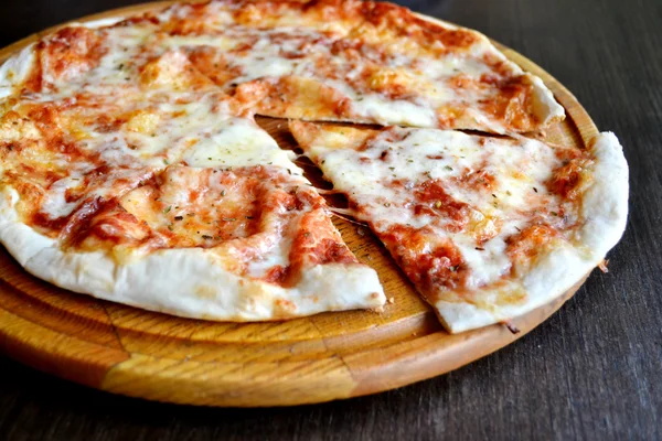 Whole pizza margherita on wooden plate — Stock Photo, Image