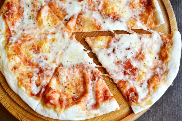 Whole pizza margherita on wooden plate — Stock Photo, Image