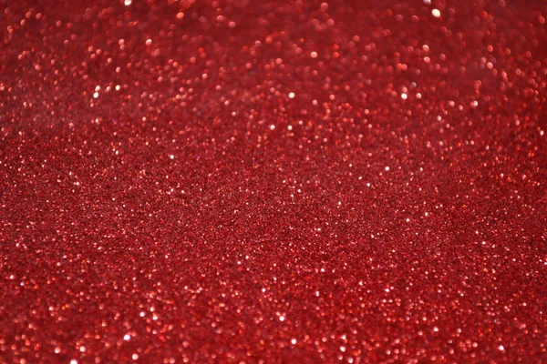 Luminoso e astratto sfondo rosso sfocato con scintillante glitter — Foto Stock