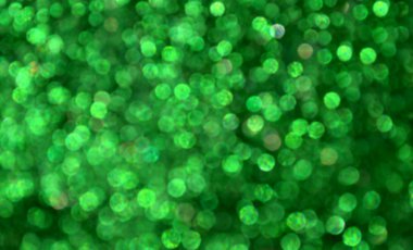 Parıldayan ile parlak ve soyut yeşil arka plan bulanık glitter