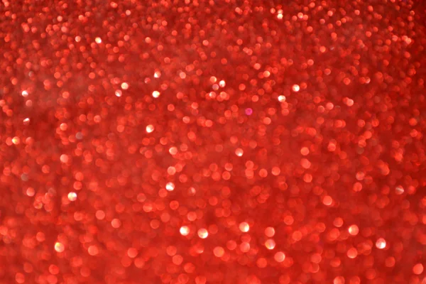 Luminoso e astratto sfondo rosso sfocato con glitte scintillante — Foto Stock