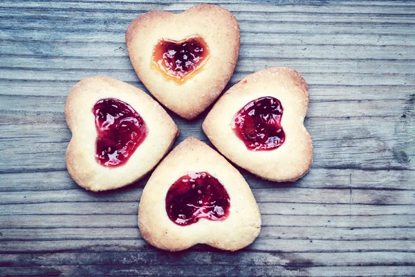 Homemade cookies with heart shaped jam on wooden table — Stock Photo, Image