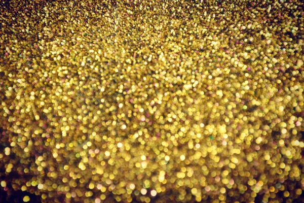 Brilhante e abstrato desfocado estrela dourada fundo com brilho cintilante — Fotografia de Stock