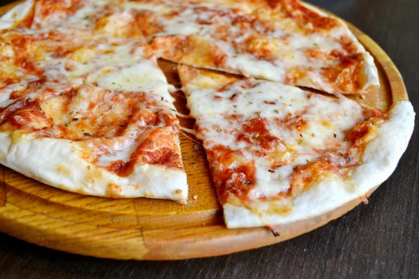 Whole pizza margherita on wooden plate — Stock Photo, Image