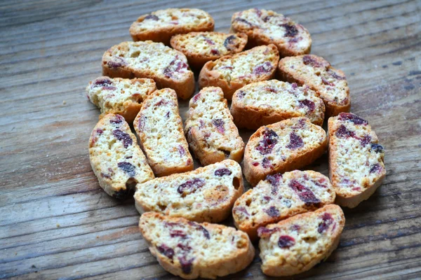 Cantuccini cookies with cranberry on wooden table — Stock Photo, Image