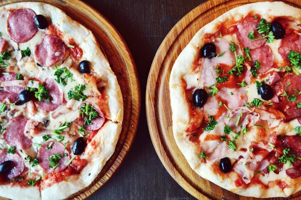 Two big hot and tasty pizzas with olives and salami — Stock Photo, Image