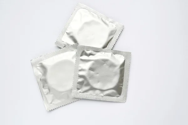 Three condoms isolated on white — Stock Photo, Image