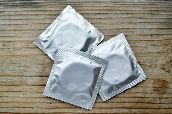 Three condoms isolated on white — Stock Photo, Image