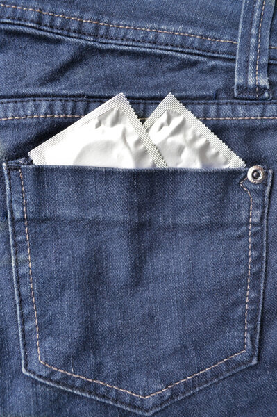 Condom in the blue jeans pocket
