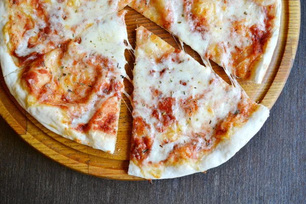 Margherita pizza inteira em placa de madeira — Fotografia de Stock