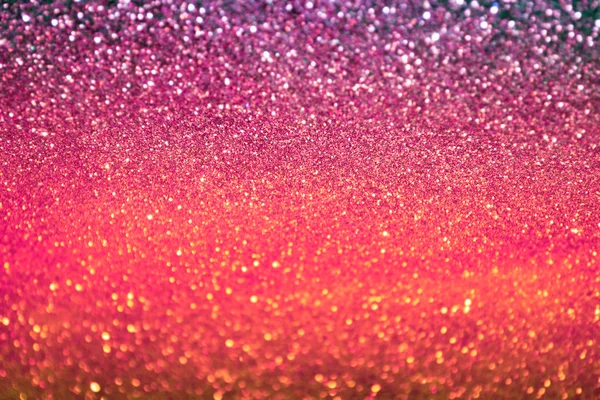 Světlé a abstraktní rozmazaný barevný duhový pozadí s třpytící se třpytí — Stock fotografie