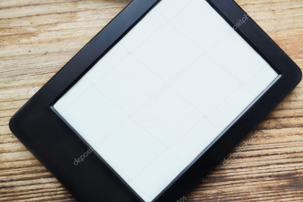 Black ereader with blank screen on wooden table Stock Photo by
