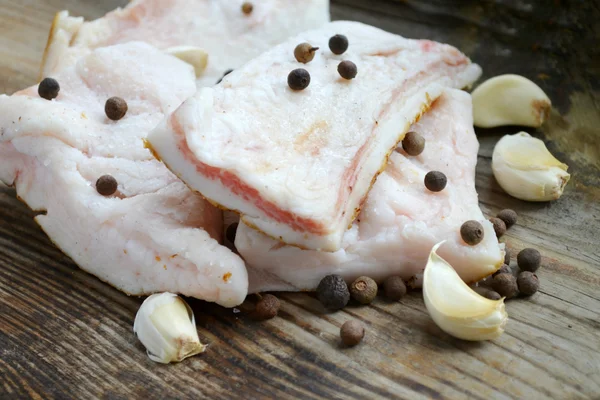 白猪肉脂肪，在木制的厨房桌子上叫做隽永的蒜和胡椒 — 图库照片