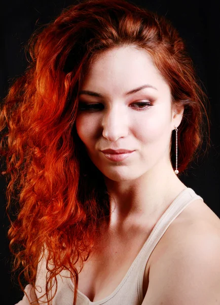 Beautiful young redhead woman with perfect daytime makeup and long silver earrings smiling playfully — Stock Photo, Image