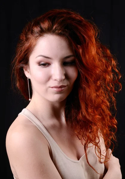 Beautiful young redhead woman with perfect daytime makeup and long silver earrings smiling playfully — Stock Photo, Image