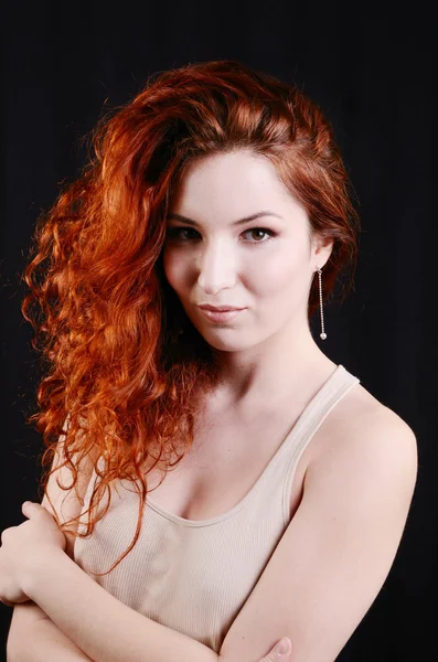 Beautiful young redhead woman with perfect daytime makeup and long silver earrings smiling playfully — Stock Photo, Image