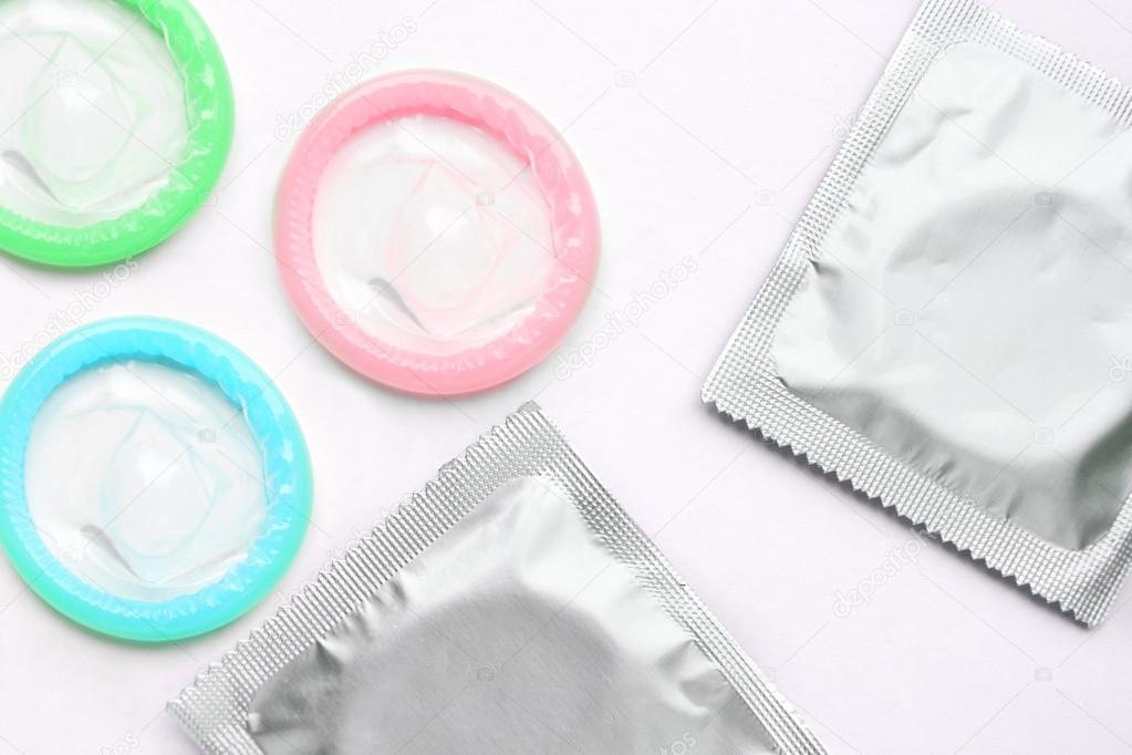 Couple of colorful condoms isolated on white
