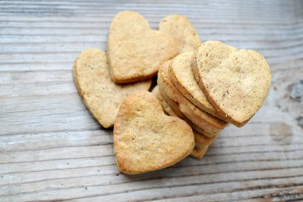 Galletas de jengibre en forma de corazón sobre mesa de madera —  Fotos de Stock