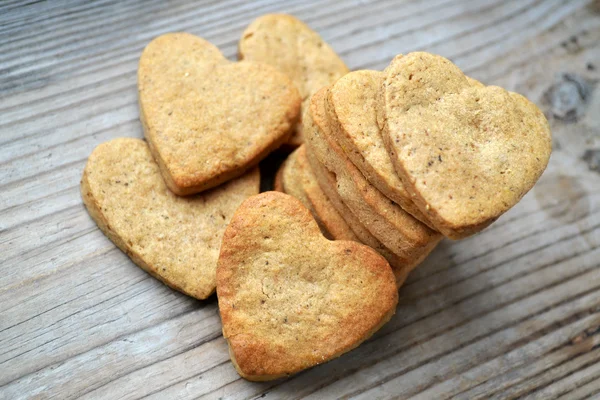 Galletas de jengibre en forma de corazón sobre mesa de madera —  Fotos de Stock