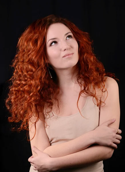 Beautiful young redhead woman with perfect daytime makeup and long silver earrings smiling — Stock Photo, Image