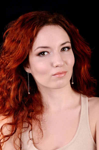 Beautiful young redhead woman with perfect daytime makeup and long silver earrings smiling playfully — Stock Photo, Image