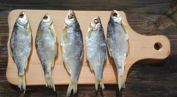 Salty stockfish cod on wooden board