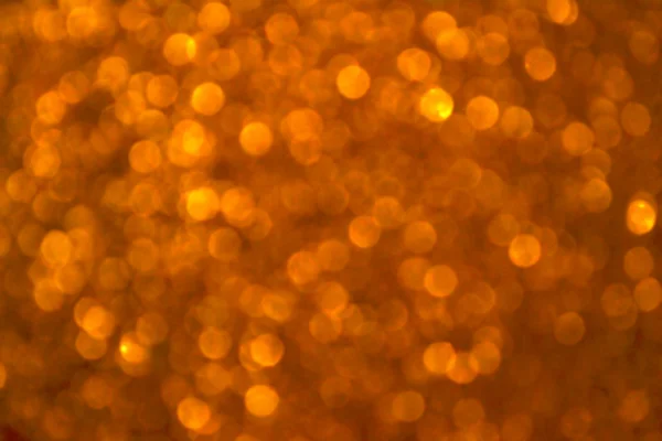 光明和抽象模糊明星金色背景与波光粼粼闪光 — 图库照片